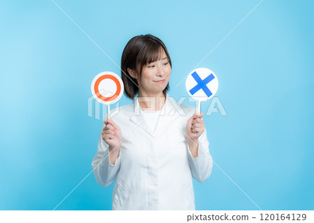 A woman wearing a white lab coat and holding a round X plate A woman wearing a white lab coat and holding a round X plate 120164129
