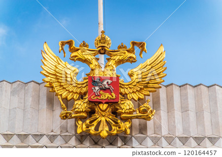 Double golden eagle. Coat of arms of Russia on the roof top of the Big Kremlin concert hall 120164457