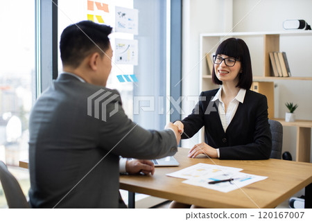 Professional handshake between business partners in modern office setting Professional handshake between business partners in modern office setting 120167007
