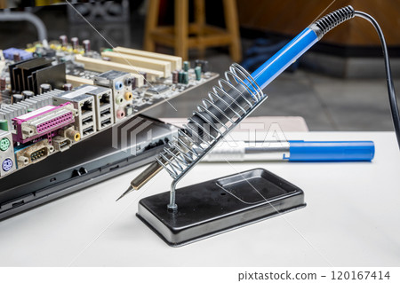 Electric solder with lead solder and motherboard circuit board on the table Electric solder with lead solder and motherboard circuit board on the table 120167414