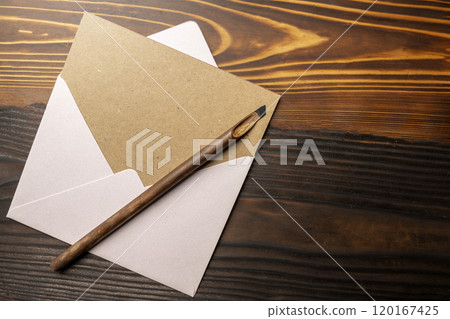 Calligraphy reeds with envelope and brown card on the table 120167425