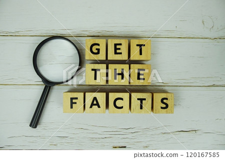 Get The Facts with wooden blocks alphabet letters and magnifying glass on wooden background 120167585