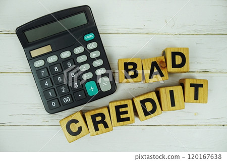 Bad Credit alphabet letters with calculator top view on wooden background 120167638