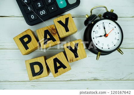 Pay Day alphabet letters with calculator and alarm clock top view on wooden background Pay Day alphabet letters with calculator and alarm clock top view on wooden background 120167642