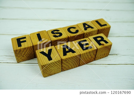 Fiscal Year with wooden blocks alphabet letters on wooden background 120167690