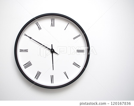 Clock Showing 17.50 or 05.50 with Roman Numerals. Simple Round Clock for Concepts of Time Management and Scheduling. Clock Showing 17.50 or 05.50 with Roman Numerals. Simple Round Clock for Concepts of Time Management and Scheduling. 120167836