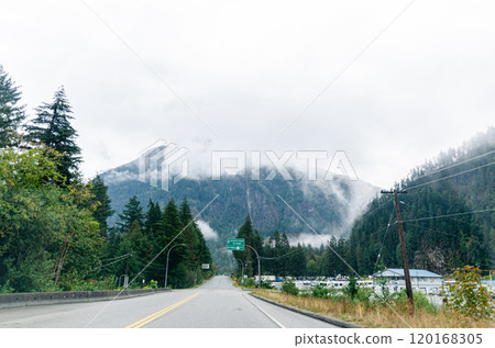 Highway in Hope BC, Canada with cloud covered mountains in the background Highway in Hope BC, Canada with cloud covered mountains in the background 120168305