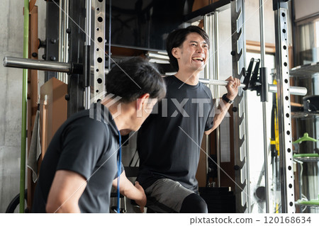 An Asian man and his trainer who push and improve their skills with one-on-one instruction at a gym/personal gym An Asian man and his trainer who push and improve their skills with one-on-one instruction at a gym/personal gym 120168634