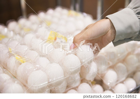 年輕女子在超市拿起雞蛋盒 120168682