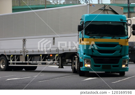 A trailer truck turning right at an intersection 120169598