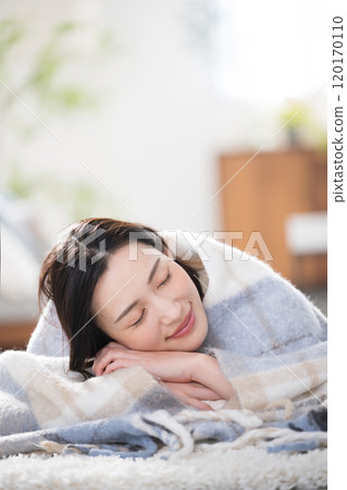 Close-up of a beautiful woman relaxing in a warm room, sleeping with her eyes closed Image of an autumn/winter room Close-up of a beautiful woman relaxing in a warm room, sleeping with her eyes closed Image of an autumn/winter room 120170110