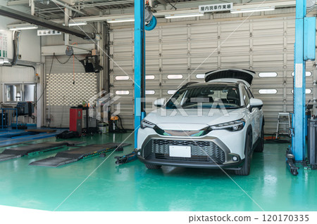 Cars in a car repair shop/pit Cars in a car repair shop/pit 120170335