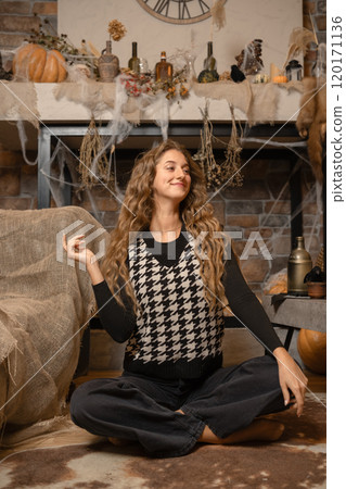 A woman in a houndstooth sweater relaxes amidst cozy autumn decorations at home A woman in a houndstooth sweater relaxes amidst cozy autumn decorations at home 120171136