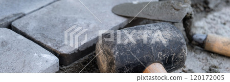 Laying paving stones on cement mortar. Banner. Laying a garden path made of tiles. Self-laying of concrete paving slabs in the courtyard of the house. do it yourself. DIY 120172005