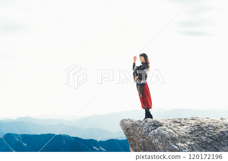 A woman standing on the fire rocks of Iwashi Plateau A woman standing on the fire rocks of Iwashi Plateau 120172196