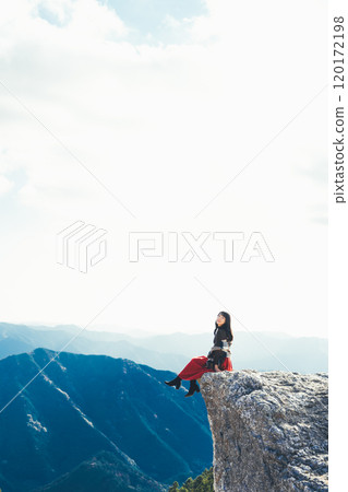 A woman sitting on the fire rocks of Oishi Plateau A woman sitting on the fire rocks of Oishi Plateau 120172198