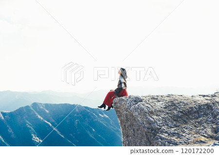 A woman sitting on the fire rocks of Oishi Plateau A woman sitting on the fire rocks of Oishi Plateau 120172200