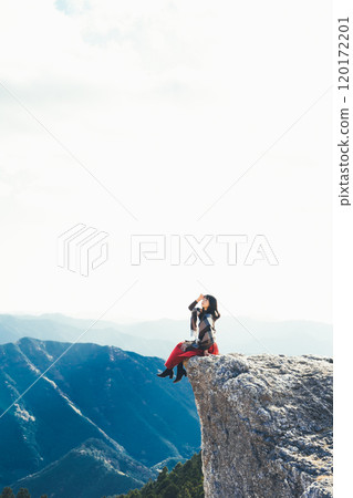 A woman sitting on the fire rocks of Oishi Plateau A woman sitting on the fire rocks of Oishi Plateau 120172201