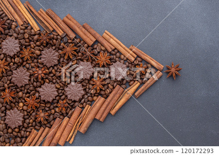 Food background. Coffee beans, cinnamon sticks, anise stars and chocolate candies. Food background. Coffee beans, cinnamon sticks, anise stars and chocolate candies. 120172293