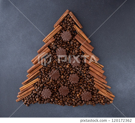 Christmas tree aroma food background. Coffee beans, cinnamon sticks and chocolate candies. Christmas tree aroma food background. Coffee beans, cinnamon sticks and chocolate candies. 120172362