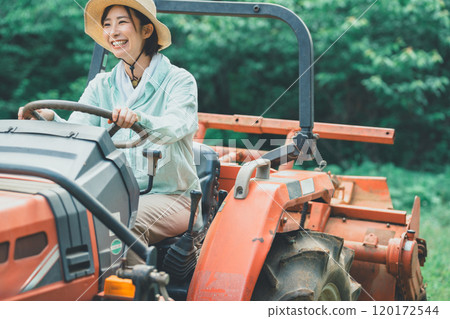 Woman driving a tractor 120172544