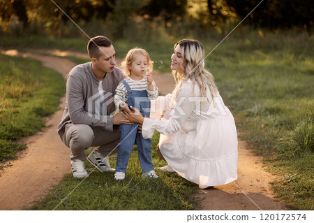 Happy family walking in the park in summer 120172574