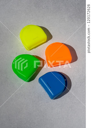 Multi-colored containers for dental plates. Box for orthodontic mouthguard. Multi-colored containers for dental plates. Box for orthodontic mouthguard. 120172626