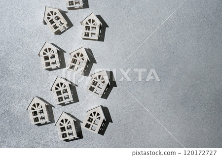 Wooden toy houses. Gray background Wooden toy houses. Gray background 120172727