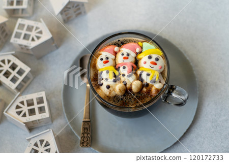 Cup of coffee with marshmallows. Marshmallow snowman in a Santa Claus hat. Winter drink. Christmas sweet food. Top view 120172733