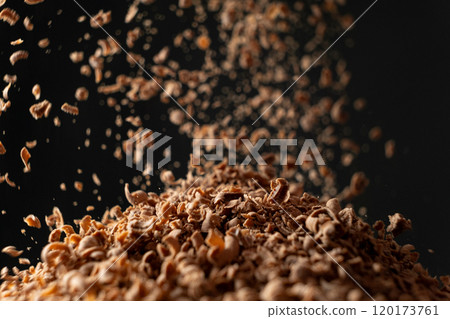 Shredded natural organic chocolate pour on black background 120173761