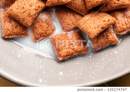 Chocolate cereal corn squares in rice milk, highlighting a mix of soft and crunchy textures, ideal for a delicious breakfast. Top view 120174747