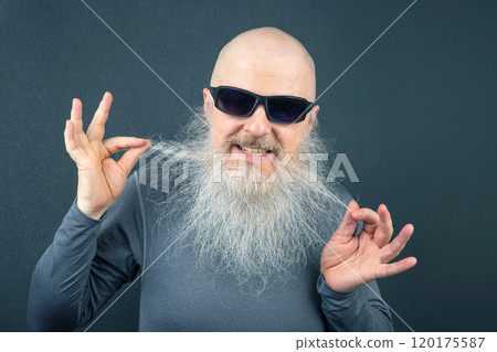 cheerful bald man stretching out his hands to highlight the long white beard flowing down his chest cheerful bald man stretching out his hands to highlight the long white beard flowing down his chest 120175587
