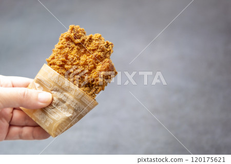 Fried chicken in hand Fried chicken in hand 120175621