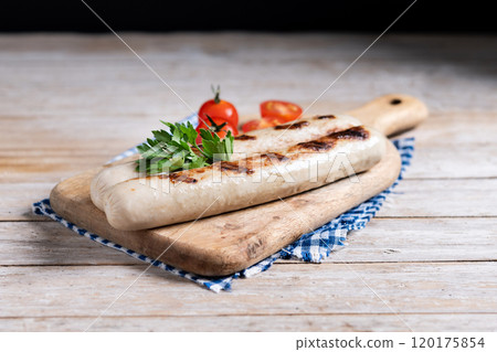 Grilled bratwurst sausages with tomatoes on wooden table Grilled bratwurst sausages with tomatoes on wooden table 120175854
