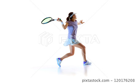Focused on game, female tennis athlete swinging racket, ready to backhand and make powerful hit against white studio background. Focused on game, female tennis athlete swinging racket, ready to backhand and make powerful hit against white studio background. 120176208