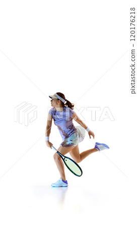 Dynamic photo of young woman leaping forward, prepares to hit, every part of tennis athlete's body aligned with moment against white studio background. 120176218