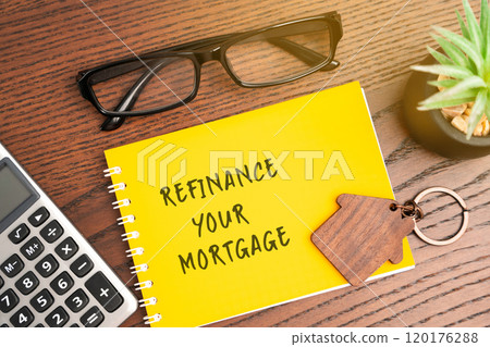Refinance your mortgage concept. Process of obtaining a new loan to replace an existing home loan, often to secure better terms. Real estate and finance. Notebook, house and calculator on table Refinance your mortgage concept. Process of obtaining a new loan to replace an existing home loan, often to secure better terms. Real estate and finance. Notebook, house and calculator on table 120176288