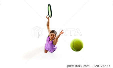 Athlete stretches her arm in leap, eyes locked on ball, embodying strength and precision, against white studio background. 120176343