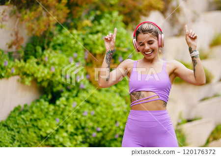 A Fitness Enthusiast Dancing Joyfully in Beautiful Nature Surrounded by Good Vibes A Fitness Enthusiast Dancing Joyfully in Beautiful Nature Surrounded by Good Vibes 120176372