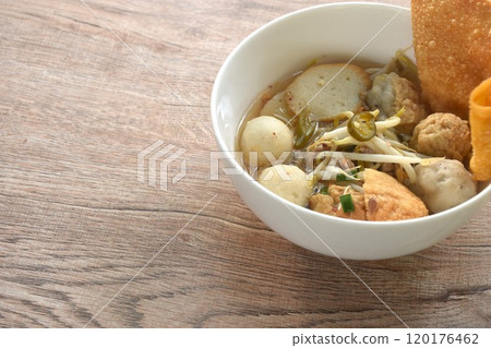 boiled Hakka meatball made from chop pork stuffing fried tofu with bean sprout and fish ball  topping crispy dumpling in spicy tom yum soup on bowl 120176462