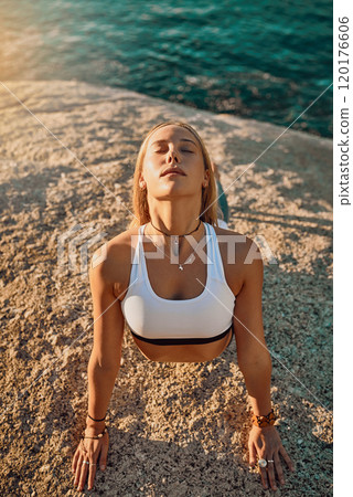 Beauty is a light in the heart. Shot of an athletic young woman practicing yoga on the beach. Beauty is a light in the heart. Shot of an athletic young woman practicing yoga on the beach. 120176606