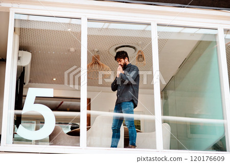 I hope this works out. Shot of a young businessman looking anxious while standing at a glass wall in an office. I hope this works out. Shot of a young businessman looking anxious while standing at a glass wall in an office. 120176609
