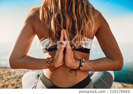 I got my own back. Rearview shot of a young woman practicing yoga on the beach. 120176668