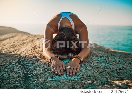 Feel the positivity flowing through your body. Shot of a woman practising the child pose at then beach. Feel the positivity flowing through your body. Shot of a woman practising the child pose at then beach. 120176675