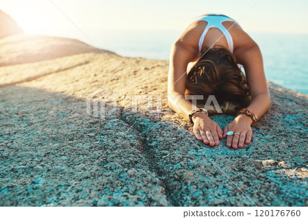 Make time for a yoga session. Shot of an athletic young woman practicing yoga on the beach. Make time for a yoga session. Shot of an athletic young woman practicing yoga on the beach. 120176760
