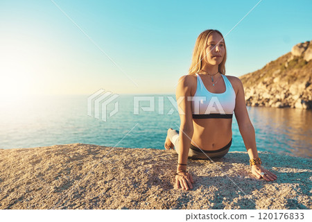 Yoga is always a good idea. Shot of an athletic young woman practicing yoga on the beach. 120176833