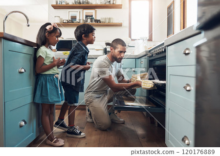 Bake the world a better place. Shot of a young man baking at home with his two young kids. Bake the world a better place. Shot of a young man baking at home with his two young kids. 120176889