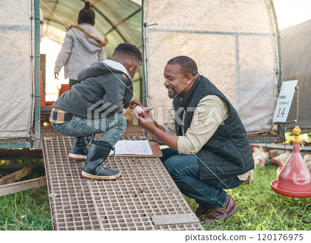 A day on the farm is like a day at school. Shot of a man working with his adorable son on a chicken farm. A day on the farm is like a day at school. Shot of a man working with his adorable son on a chicken farm. 120176975