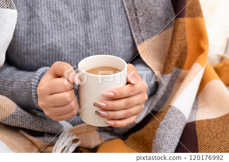 Female hands holding a white mug of coffee 120176992