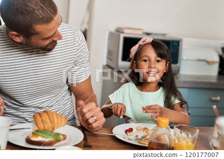 Breakfast is the perfect way to start your day. Cropped shot of a man and his adorable daughter having breakfast at home. Breakfast is the perfect way to start your day. Cropped shot of a man and his adorable daughter having breakfast at home. 120177007